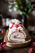 Raspberry sponge cake roll with cream cheese filling