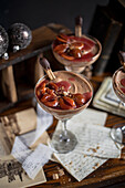Gingerbread mousse with plum compote served in cocktail glasses