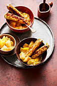 Filo pastry rolls with figs and apricots on mango and apple compote