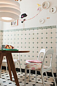 Breakfast table with minimalist chairs in a tiled kitchen