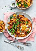 Rösti topped with chanterelles, fried egg and green beans