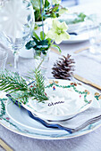 Christmas place setting decorated with a sprig of conifer