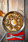 Frying pan pizza bianco with mushrooms and egg