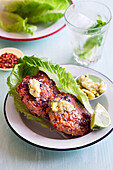 Chicken patties with salad, lime, and herb butter