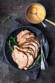 Slow cooked meat with cream sauce and rosemary