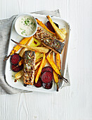 Roast salmon with a mustard crust and vegetables served with horseradish sauce