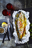 Sea bass with fennel, lemon and spices cooked in foil