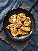 Roasted pork medallions on a black plate