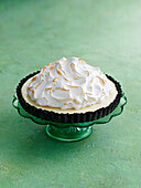 Oreo meringue pie on a green cake stand