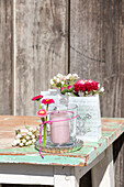 Lantern decorated with bellis and gift bags with spring bouquets