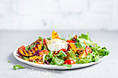 A salad with grilled nectarines and buffalo mozzarella