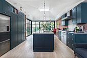 Open kitchen with classic cabinets and Shaker style kitchen island