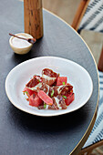 Cold cured meat salad with pickled raddish and watermelon