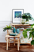 Wooden table and stool with houseplants