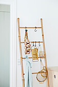 Bamboo ladder with garlic braid and kitchen utensils