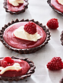 Chocolate tartlets with raspberry filling