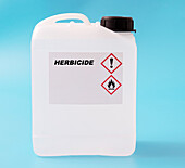 Herbicide in a plastic canister, conceptual image
