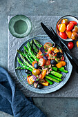 Asparagus topped with tuna salad with tomatoes