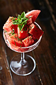 Watermelon salad with mint served in a stemmed glass