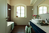 A view of a washstand with a countertop sink and a bouquet of flowers