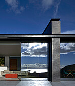 A house with a window wall reflecting the sea