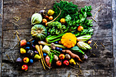 Autumn fruits and vegetables on a rustic wooden table