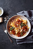 Papardelle with beef in tomato sauce, basil pesto, pine nuts and Parmesan cheese
