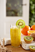 Orange-and-kiwi juice with ice cubes
