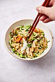Vegetable zoodles with edamame and peanut-coconut sauce