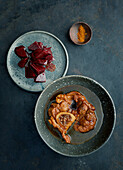 Braised veal shank slices with mandarin zest and beets
