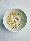 Clear won ton soup with coconut mushroom and buckthorn fruit