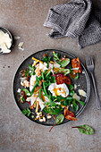 Bean salad with bacon, herbs and a poached egg