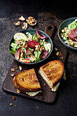 Chicory salad with red onions, apples and walnuts served with hot Limburger bread