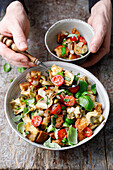 Bread salad with artichokes, tomatoes, capers and basil