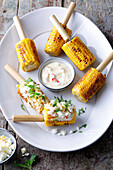Grilled corn on the cob with herb and feta cheese dip