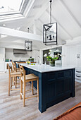 Blue kitchen island with marble worktop