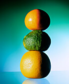 Citrus fruits (grapefruit, yuzu, pomelo), stacked on top of each other