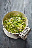 Chopped fresh endive salad in a colander