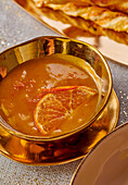 Orange sauce in a golden bowl