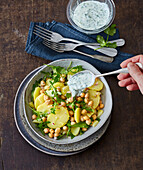 Chickpea and potato salad with rocket leaves