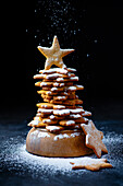Ginger cookies stacked in a shape of a christmas tree