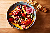 Vegetable salad with carrots, tomatoes, beetroot and walnuts