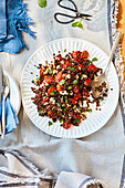 Tomato salad with lentils, feta and golden garlic