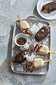Fruit popsicles dipped in white and dark chocolate and sprinkled with dried flowers