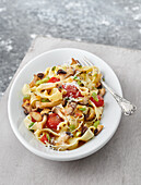 Pasta with herb mushrooms, cherry tomatoes and parmesan cheese