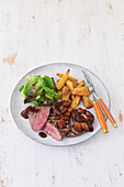 Rodeo Steak with potato wedges and pearl onions