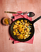Roast potatoes with cinnamon, almonds and sultanas