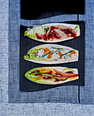 Romaine lettuce three ways: with ham, with blue cheese and with anchovies