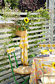 Outdoor table setting, basket with sunflower as fence decoration