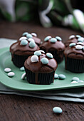 Vegan chocolate mint muffins with dark chocolate icing and mint dragees